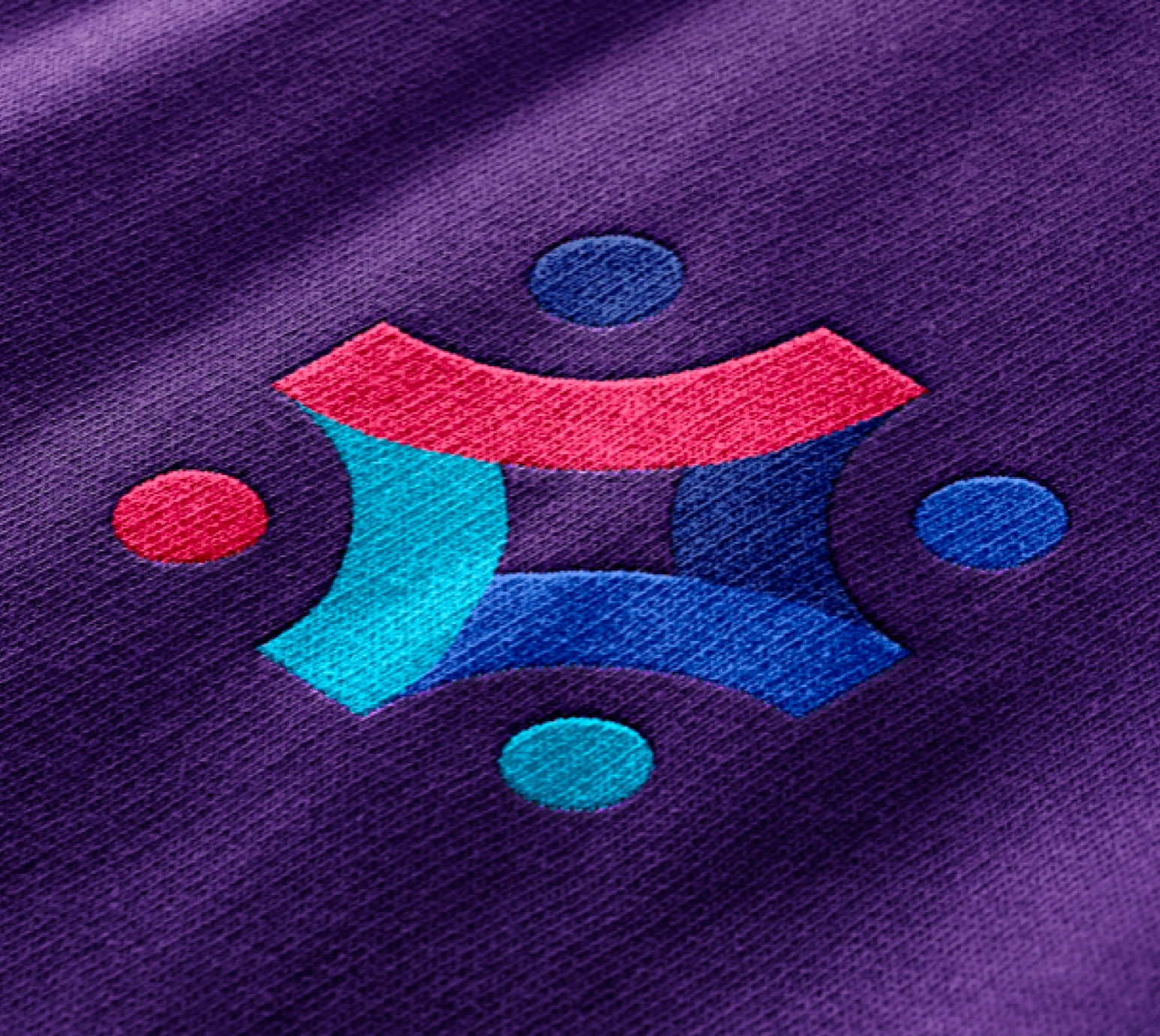 Care Suite logo embroidered on purple fabric.