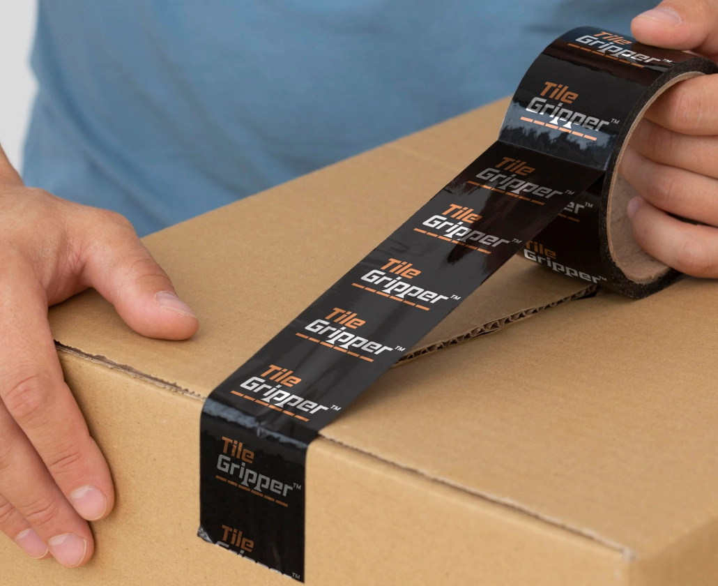 Tile Gripper branded packing tape applied to a shipping box.